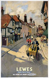 <b class=qtipBold><figcaption>'Lewes', BR poster, 1955</figcaption></b><br>Poster produced for British Railways (BR), Southern Region (SR), showing a view of a street in the East Sussex town of Lewes, where a man is seen pushing a scissor-grinding machine. Artwork by Terence Cuneo (1907-1996), son of the artists Cyrus and Nell Cuneo. He studied at the Chelsea and Slade Art Schools and in addition to a long career designing railway posters, he also painted portraits (including royal portraits) and ceremonial and military subjects. <br><em>© Please read our licence terms. All digital images must be destroyed unless otherwise agreed in writing.</em> 'Lewes', BR poster, 1955